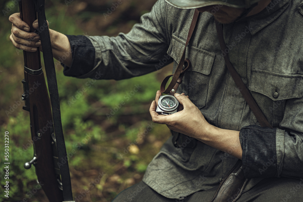 Soldier Using Compass Foto de A Finnish army soldier in World War II uniform looks at a ...
