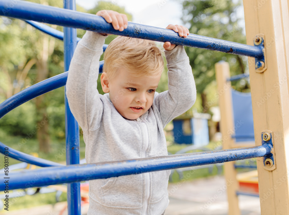 little boy playing on the playground outdoors little boy playing on the playground outdoors