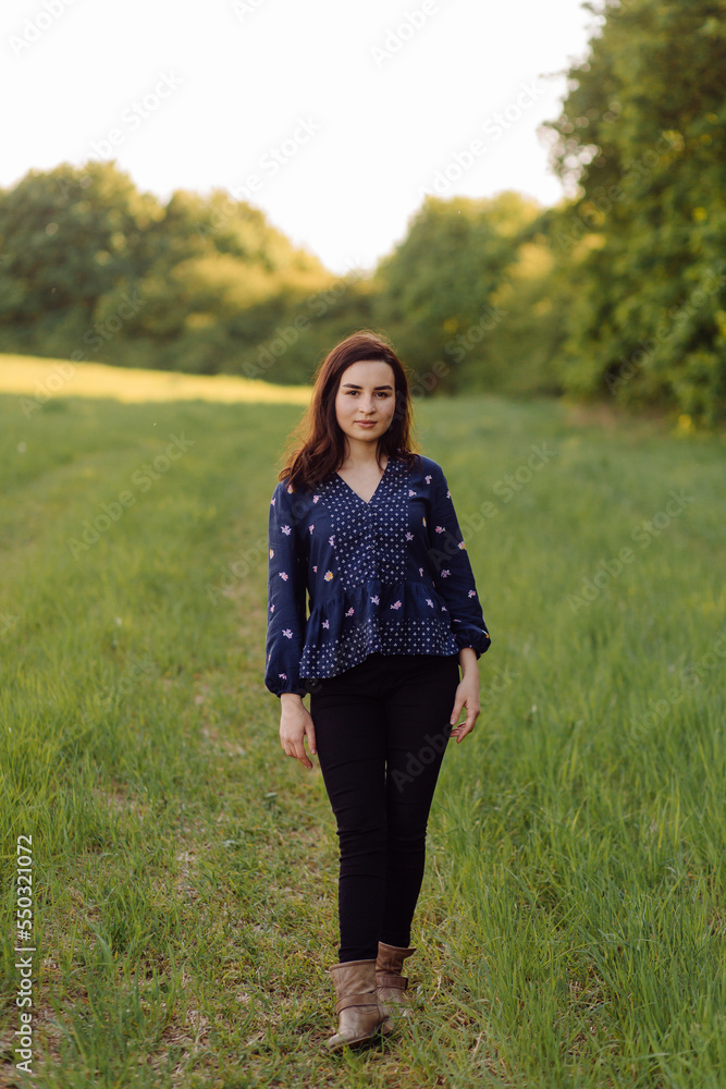 A beautiful young woman walking in the forest A beautiful young woman walking in the forest