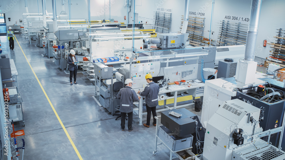 Industrial Factory: Diverse Team of Engineers, Technicians, Professionals and Workers, Working on Production Plant, Optimizing CNC Machinery, Programming Machines, Planning Projects. Elevated Shot.