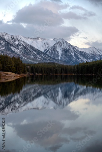 Snow covered Rocky Mountains in Banff National Park in Canada  reflect on the calm lake water.