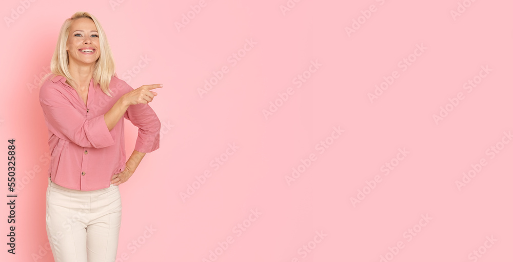 Beautiful Ukrainian woman in pink shirt on pink background.
Beautiful Ukrainian woman in pink shirt on pink background.