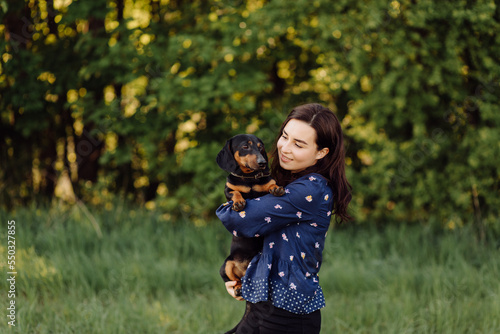 young girl on a walk with her dachshund © andriyyavor