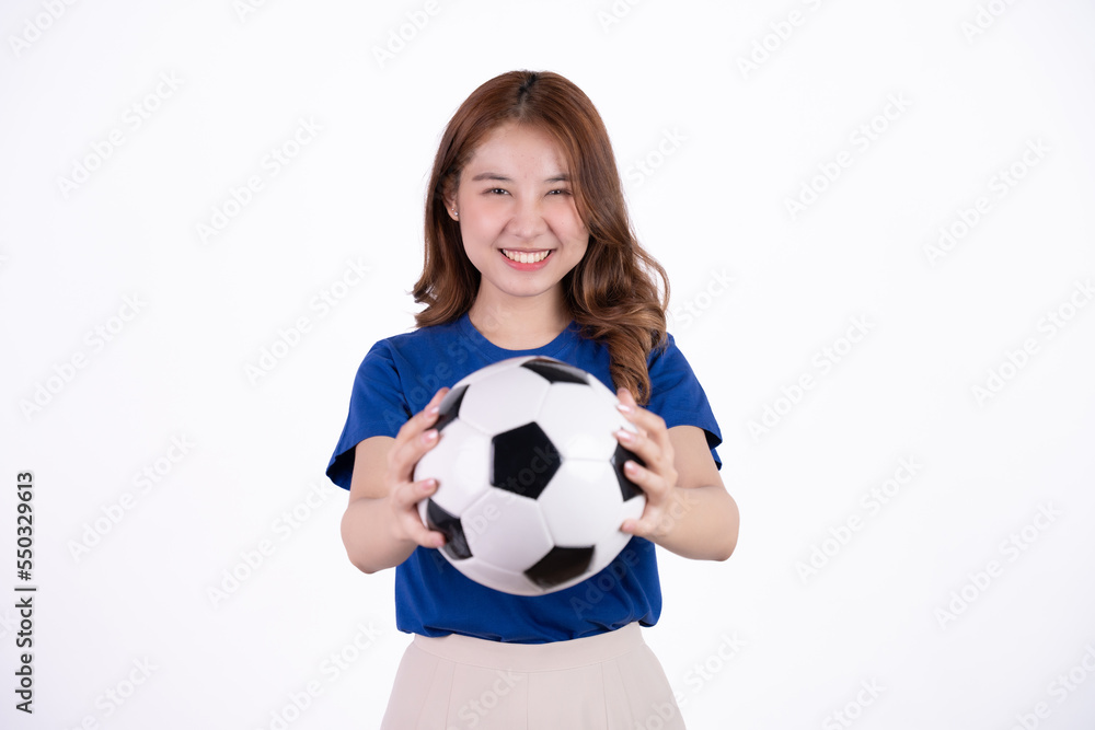 Asian woman smiling in blue t-shirt holding football to cheering the soccer game isolated on white screen background.