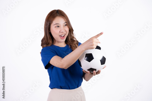 Asian woman smiling in blue t-shirt holding football to cheering the soccer game isolated on white screen background. © Parichat
