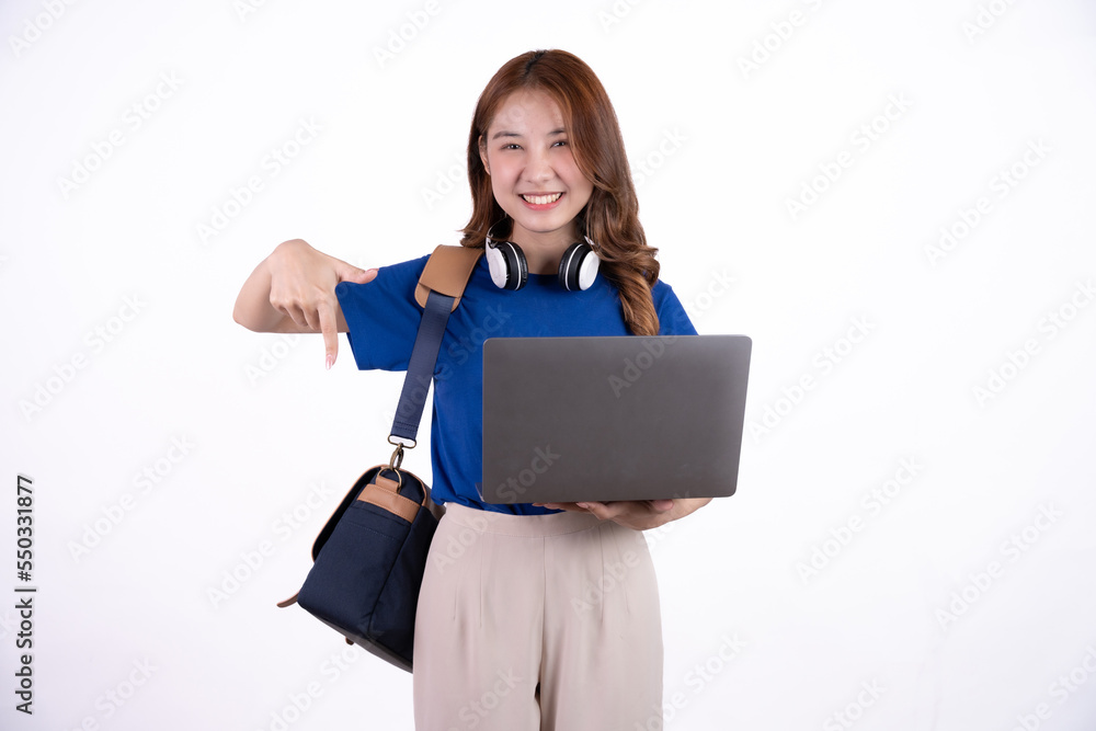 Portrait of happy young asian student girl using laptop computer isolated over white background