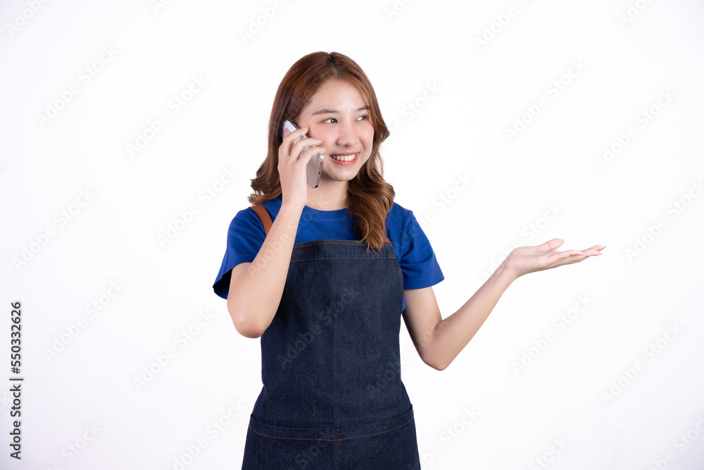 Young Asian woman cafe owner feeling happy using cellphone to advertise through social media or manage electronic banking, isolate with white background, small business owner, young confident woman. Young Asian woman cafe owner feeling happy using cellphone to advertise through social media or manage electronic banking, isolate with white background, small business owner, young confident woman.
