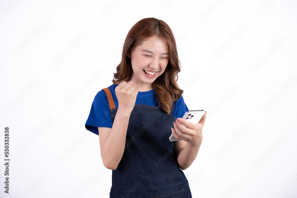 Young Asian woman cafe owner feeling happy using cellphone to advertise through social media or manage electronic banking, isolate with white background, small business owner, young confident woman. Young Asian woman cafe owner feeling happy using cellphone to advertise through social media or manage electronic banking, isolate with white background, small business owner, young confident woman.
