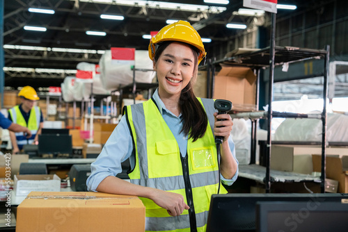 Asian female employees stand with scanners and pack products delivered to customers on time in warehouses and distribution centers.