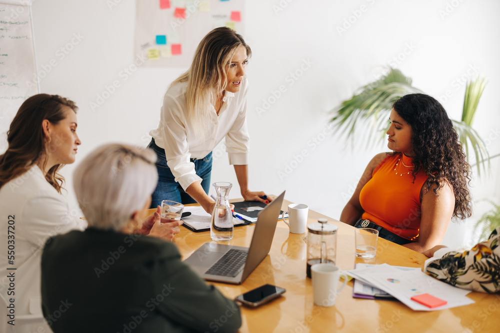 Diverse businesswomen having a boardroom meeting Diverse businesswomen having a boardroom meeting