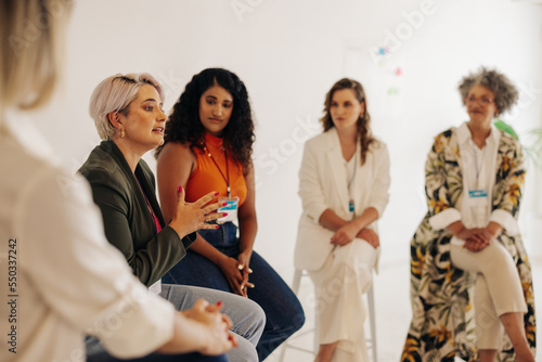 Confident businesswomen having a discussion during a conference meeting photo
