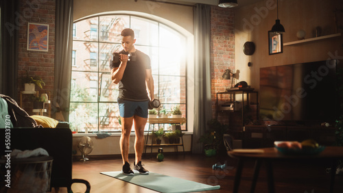 Strong Athletic Black Man Does Workout at Home, Training with Dumbbells. Fit Muscular Sportsman Staying Healthy, Training at Home. Sweat, Determination of a Handsome Mixed Raced Man. Wide Shot