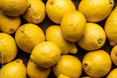 Pile of yellow lemons placed on table