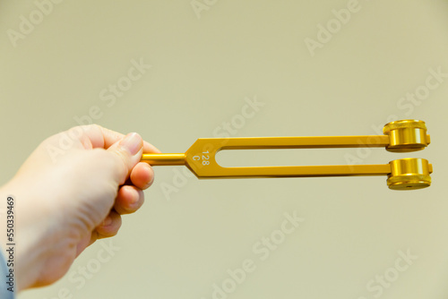Hand holding a tuning fork .