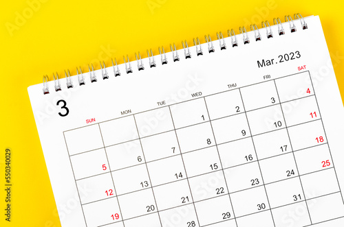 The March 2023 Monthly desk calendar for 2023 year on yellow background. © gamjai
