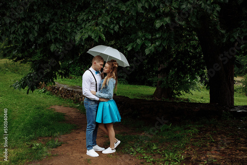 Young couple in love standing in the rain under an umbrella © Kaplitskaya Love