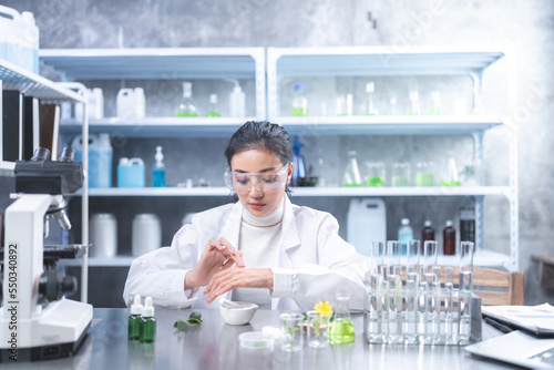 Pharmaceutical factory woman worker in protective clothing operating production line in sterile environment, scientist with glasses and gloves checking hemp plants in a marijuana farm