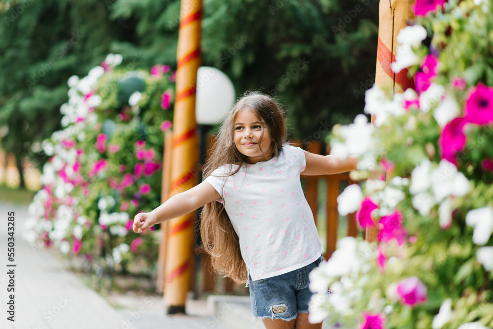 Smiling baby girl walks in the park in bright colors Smiling baby girl walks in the park in bright colors
