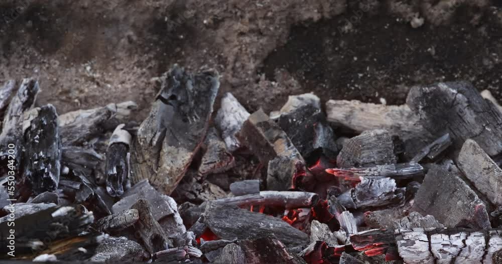 Smokey ash ember after bonfire has burned off all of firewood prepared barbecue for cooking on BBQ grill Smokey ash ember after bonfire has burned off all of firewood prepared barbecue for cooking on BBQ grill