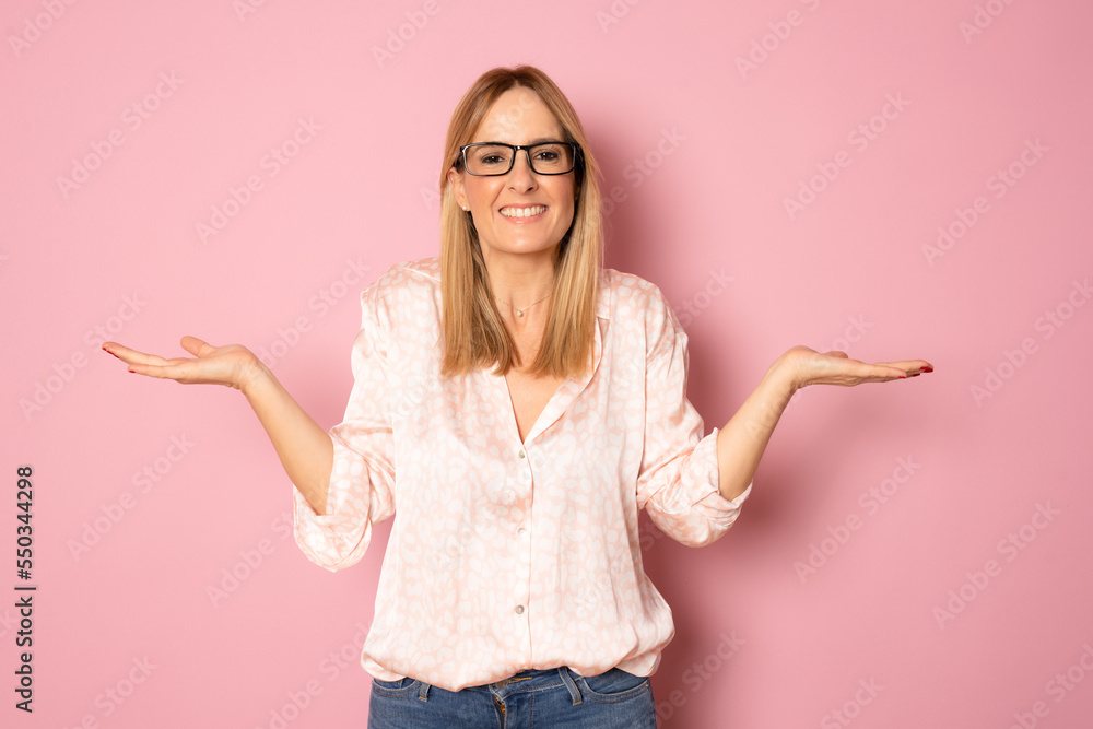 Frustrated and confused young woman raising hands and point at something bad, complaining and frowning at camera, standing bothered against pink background. Frustrated and confused young woman raising hands and point at something bad, complaining and frowning at camera, standing bothered against pink background.