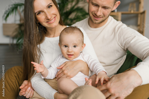 Lifestyle portrait of a young stylish family with a young son at home