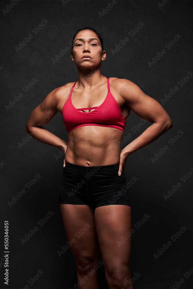 Muscular woman with hands on waist Muscular woman with hands on waist