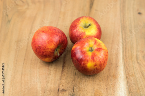 red fresh apples on a wooden surface