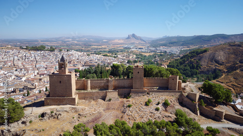 Aerial drone view of Antequera castle with the natural monument The Lovers' Rock in the background. Touristic travel to Spain. Historic interest and Unesco World Heritage Site.  photo