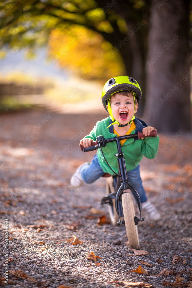 Little happy boy riding bike in park Little happy boy riding bike in park