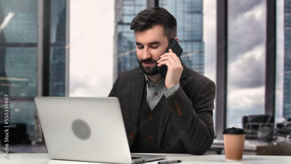 Stylish Latino man employee in suit working with customer use smartphone laptop at office downtown Stylish Latino man employee in suit working with customer use smartphone laptop at office downtown