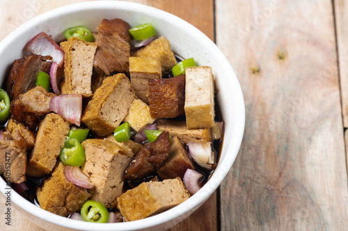 Tokwa't baboy is a typical Philippine appetizer or pulutan. It consists of pork ears, pork belly and deep-fried tofu, and is served in a mixture of soy sauce, pork broth, vinegar, chopped white onions photo
