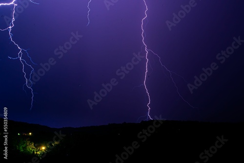 Beautiful shot of lightning isolated in the purple sky at night