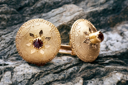 Gioiello, bottone tradizionale sardo in oro su roccia photo