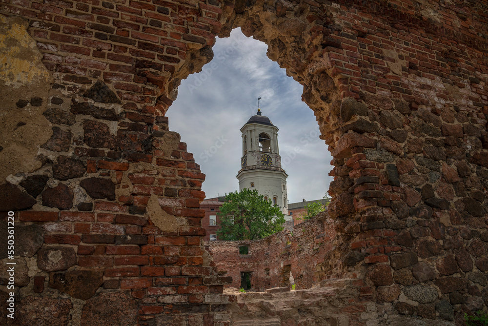 The clock tower in the opening of the wall of the destroyed cathedral. Vyborg, Leningrad region, Russia