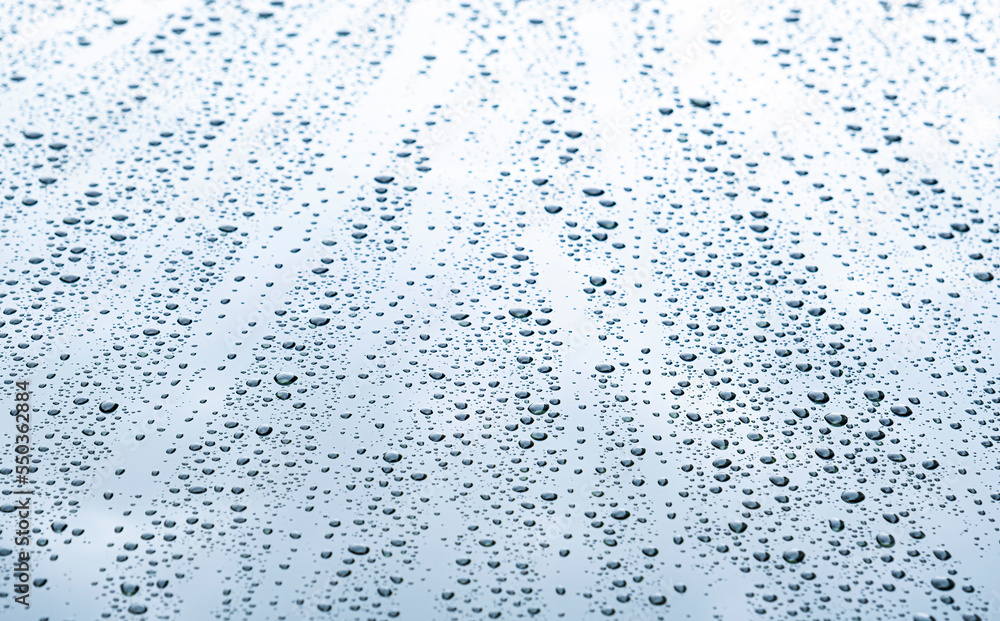 Close up rain drop on surface of car's body after passed from rainy area
