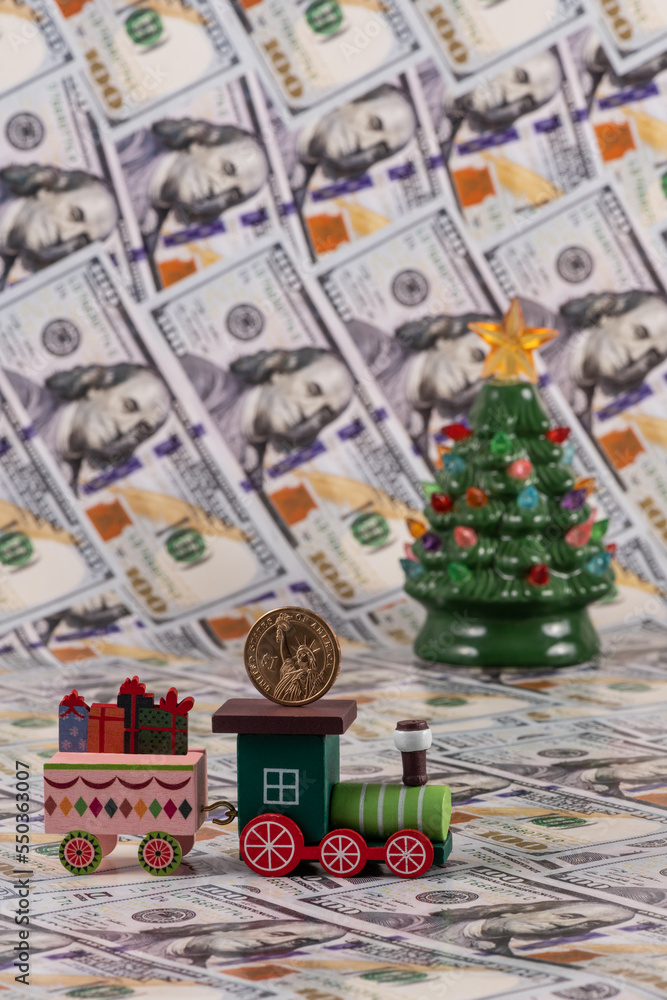 Wooden toy train, Christmas tree and American money