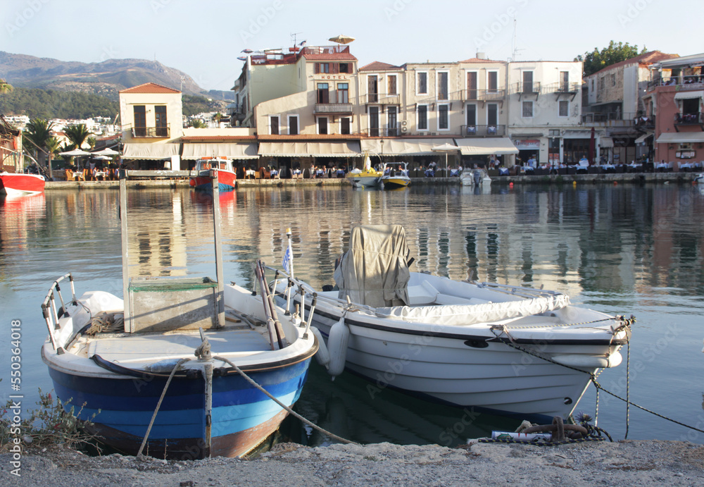 Harbor with wooden fishing boats in a mediterranean village in summer