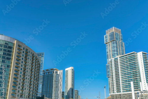 Austin Texas skyline with exterior view of luxury apartments against blue sky