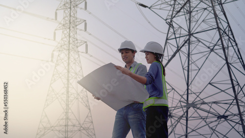 Two specialist electrical engineer working near to High voltage tower.