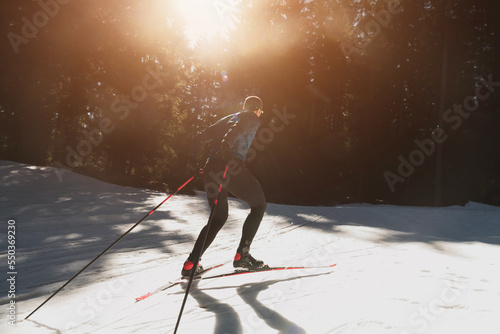 Canvastavla Nordic skiing or Cross-country skiing classic technique practiced by man in a beautiful panoramic trail at morning