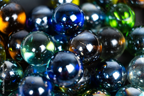 Lots of blue and green glass balls, beads on a white background, close-up