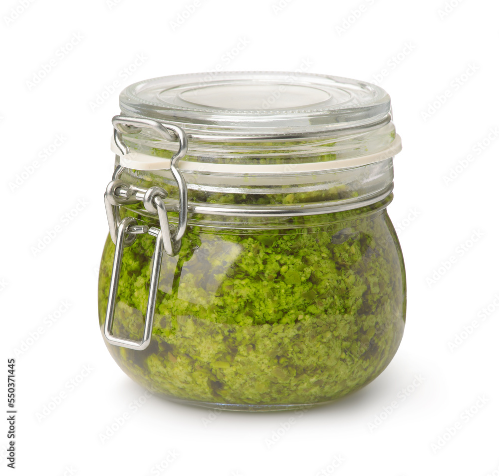 Front view of green pesto sauce in glass jar Front view of green pesto sauce in glass jar
