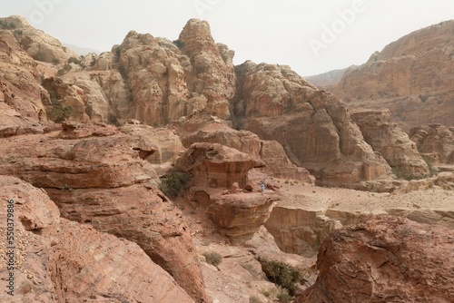 Amazing views on tourist trail to High Place of Sacrifice in ancient Nabataean city of Petra, Jordan. Petra is considered one of seven new wonders of world. Silhouettes of people on trail.