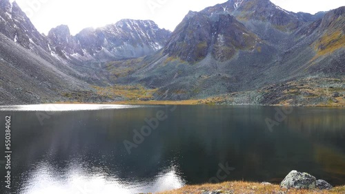 A mountain lake framed by a spectacular mountain range (sawback). Sayans. Siberia photo