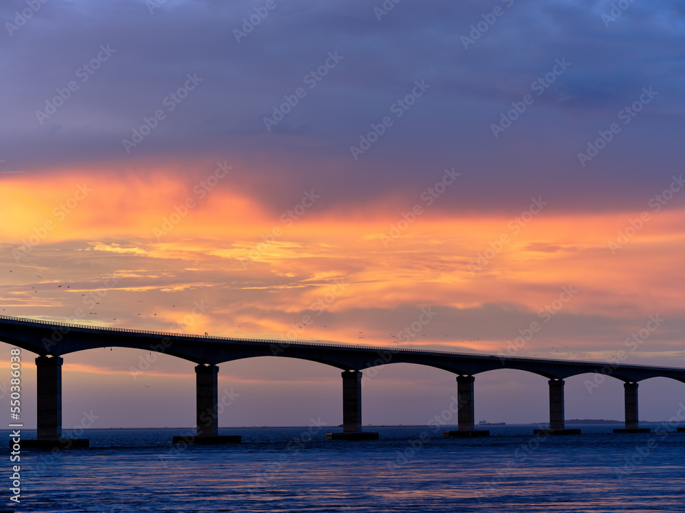 Sunset over the Herbert C Bonner new bridge spanning the Oregon Inlet on the Outer Banks of North Carolina Sunset over the Herbert C Bonner new bridge spanning the Oregon Inlet on the Outer Banks of North Carolina