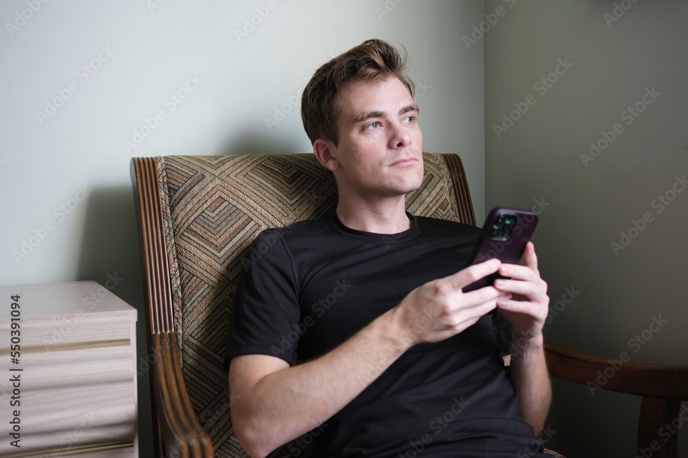 young man holding smartphone. Texting in phone young man holding smartphone. Texting in phone