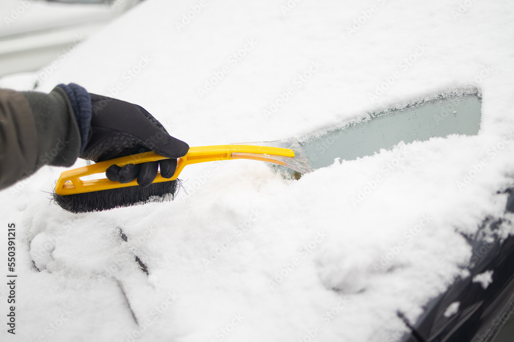 Clearing and remove snow from windshield, Scraping ice. Winter season car window cleaning. Copy space for your text. 