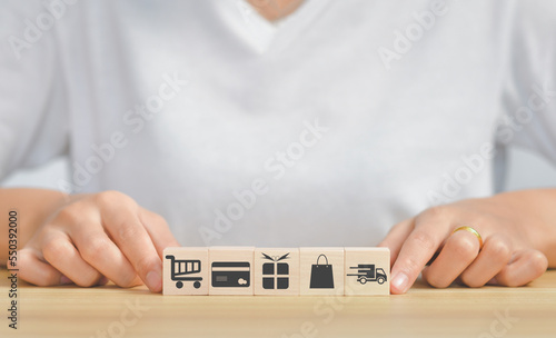 Shopping online concept.wooden cube stack,doing online banking transaction. E commerce icon, secure mobile banking concept,Shopping Online Using Mobile Phone App