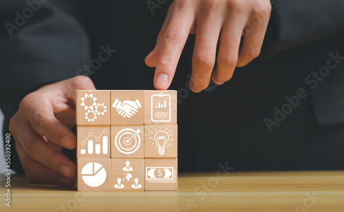 business strategy, Action plan, Goal and target, hand stack woods block step on table with icon about business strategy and Action plan. business development concept. copy space