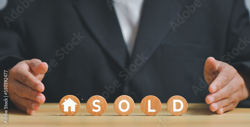Red real estate broker agent buy and sell home concept,wooden blocks and sold word on wooden cubes,insurance, loan, mortgage,Real estate consulting service